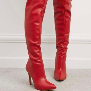 Red thigh high boots with four inch heel.